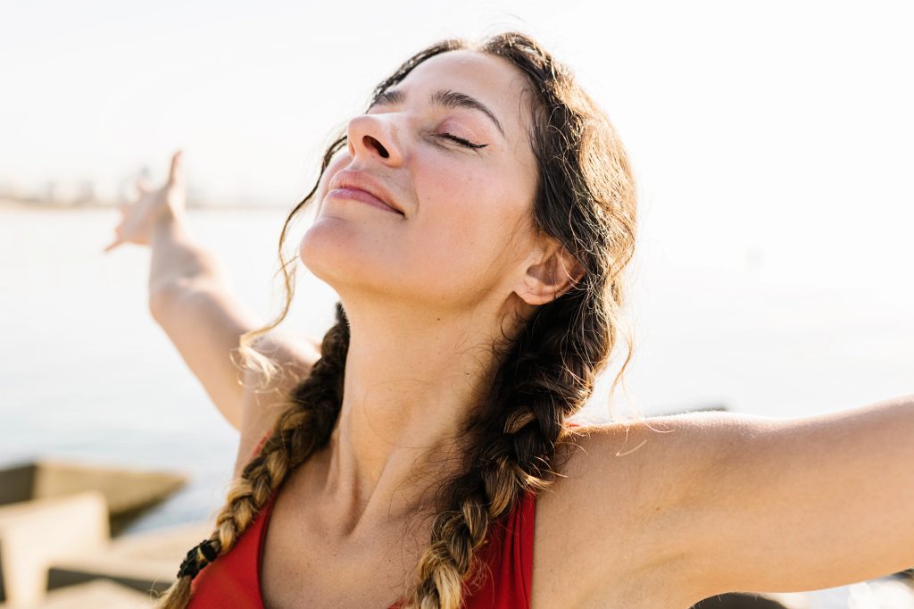 Woman taking a calming breath outdoors